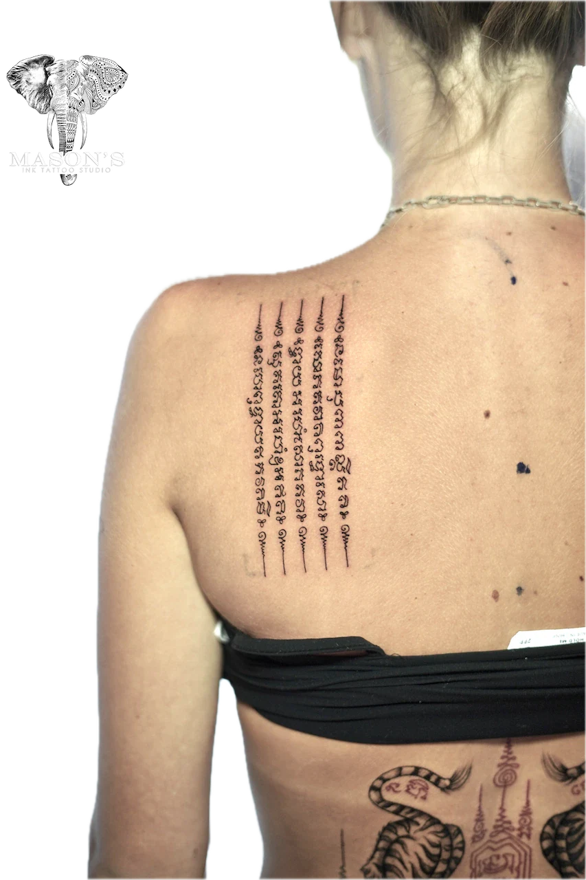 Sak Yant Tattoo Design: Spiritual lettering and mythological creatures on the back