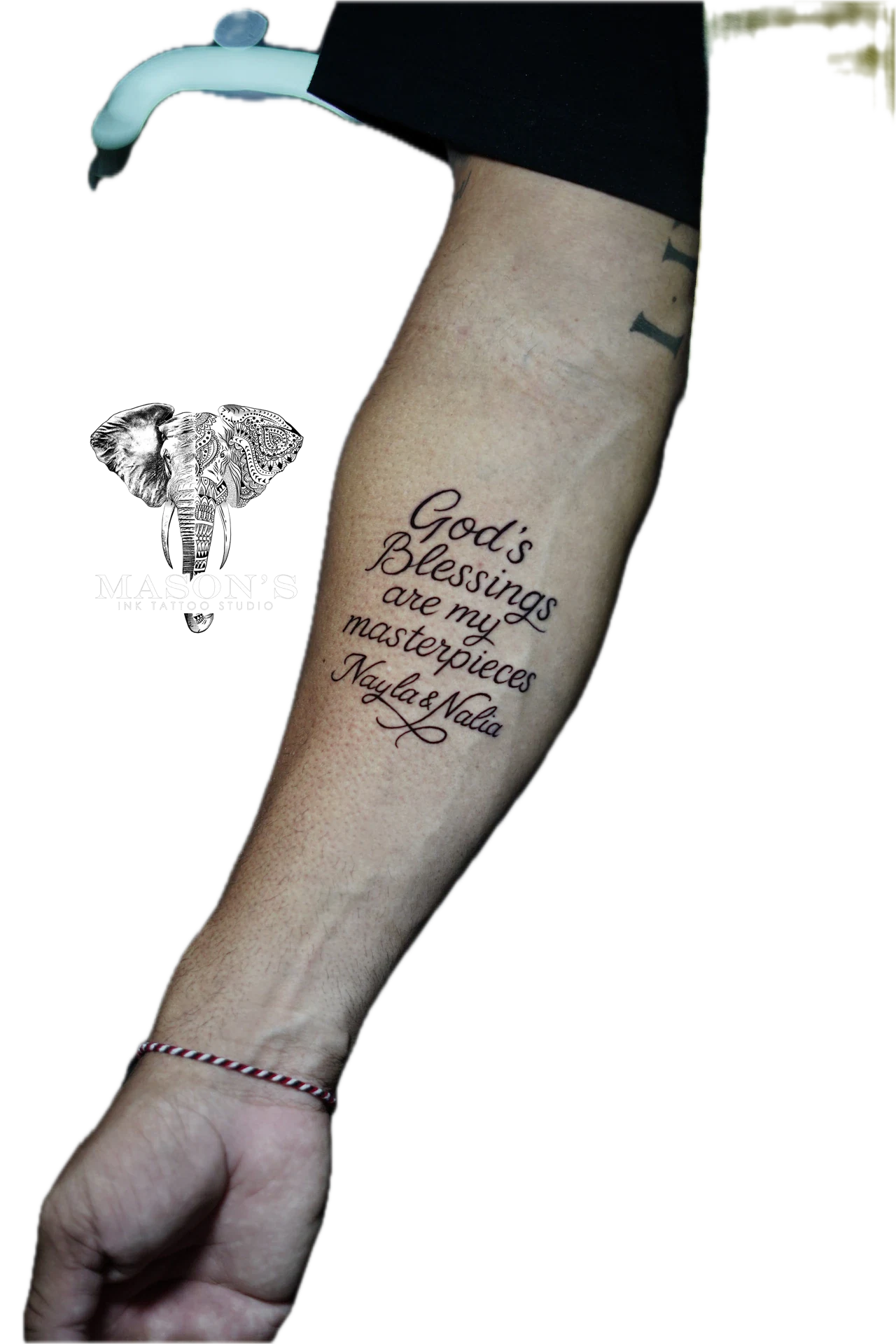 Script God Blessings Are My Masterpiece Tattoo Design: Spiritual lettering tattoo on a forearm with an elephant logo
