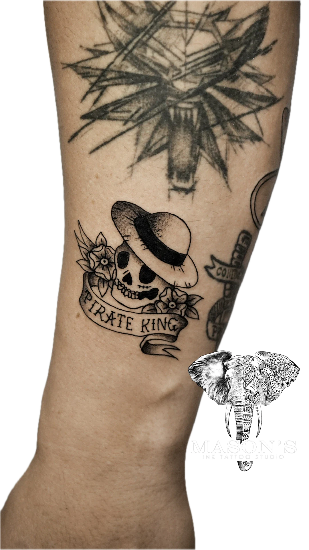 Traditional Skull and One Piece Logo Tattoo Design: a pirate-themed skull with a hat and compass on a calf