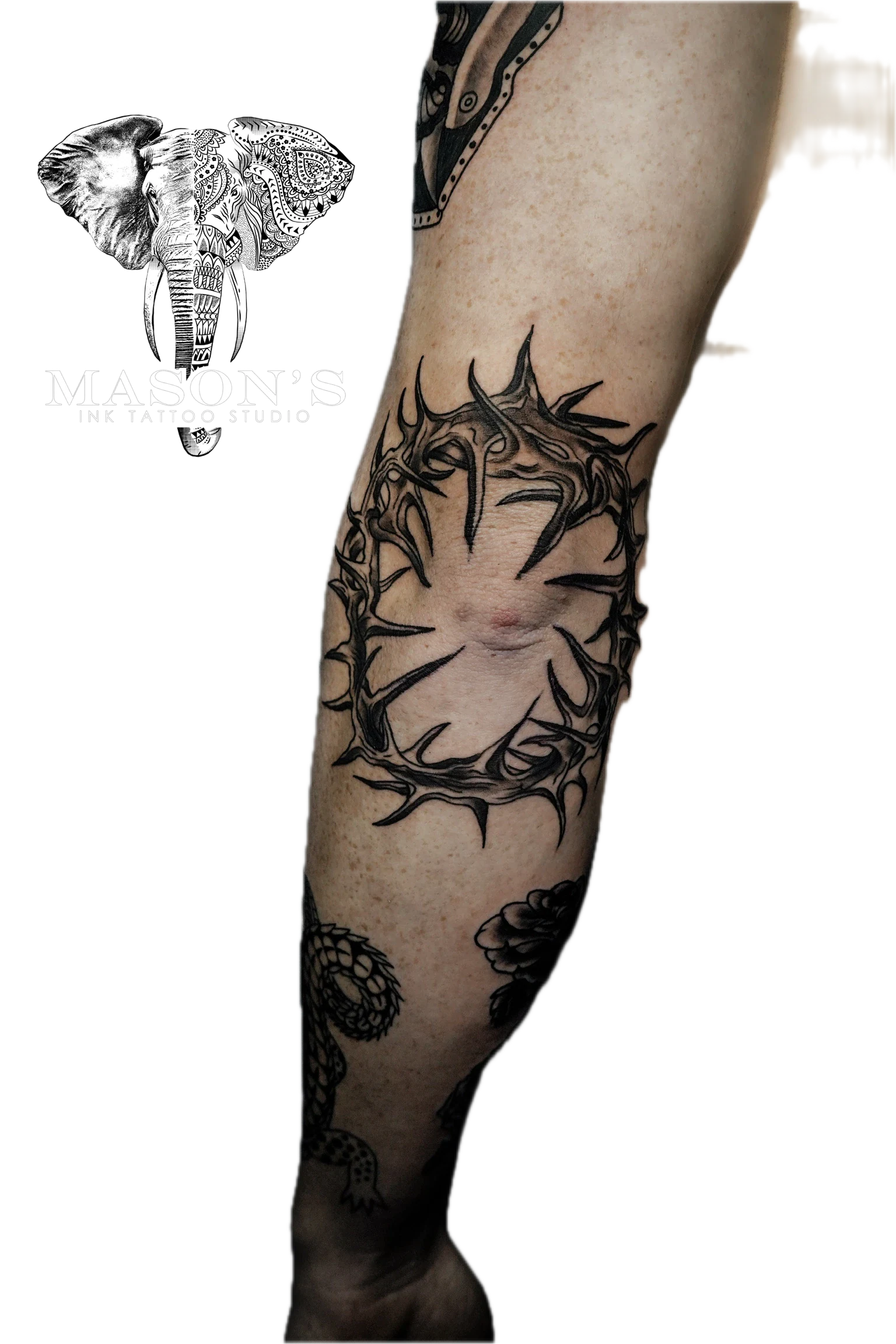 Traditional Tattoo Design: a detailed crown of thorns tattoo with snakes and flowers on a forearm