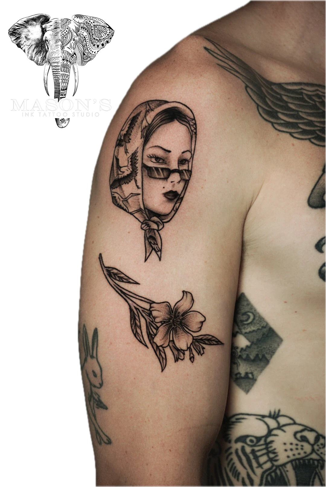Traditional Woman Tattoo Design: a detailed portrait of a woman with a bird and flowers on the upper arm
