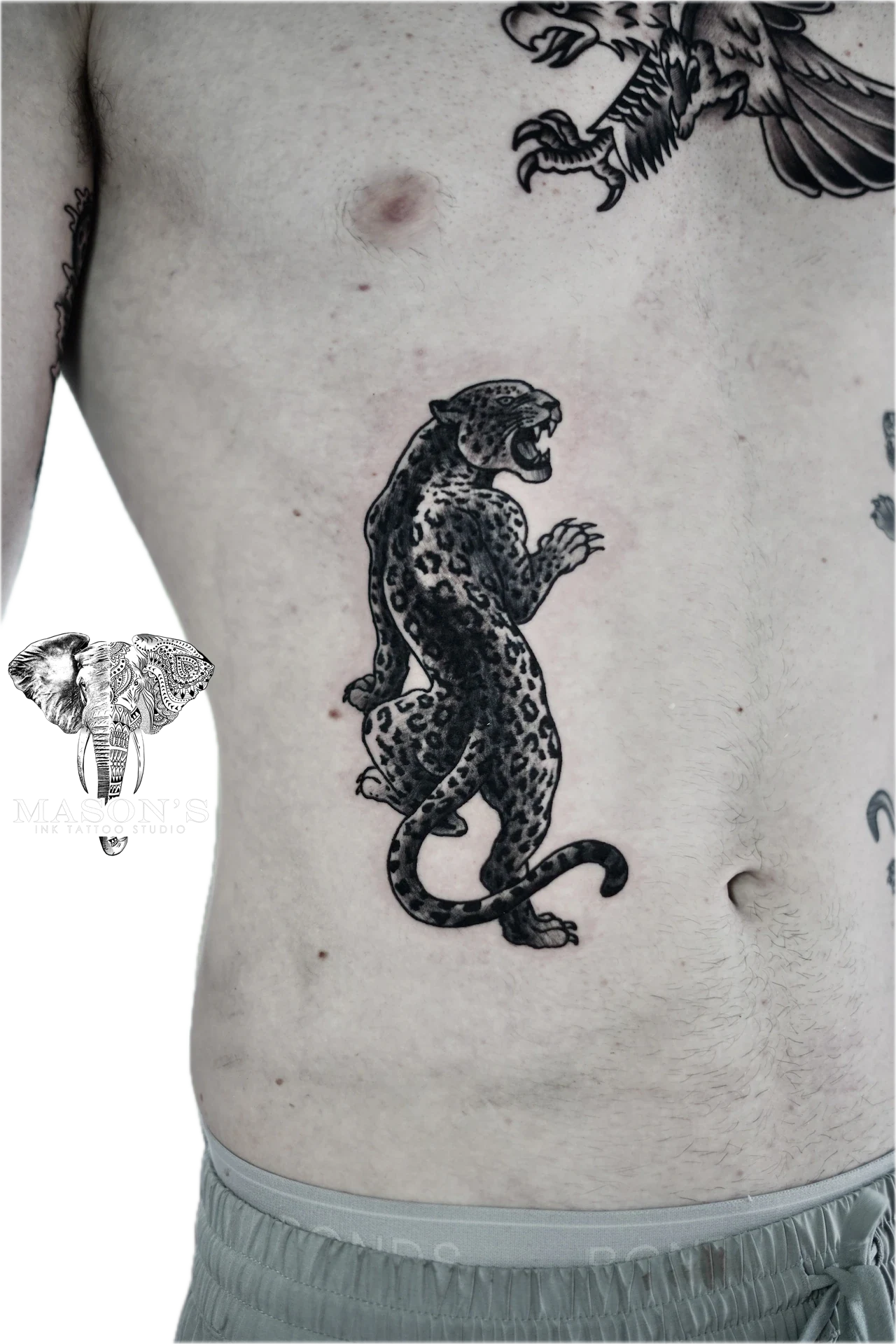 Traditional Tiger Tattoo Design: a detailed leopard standing on a stomach