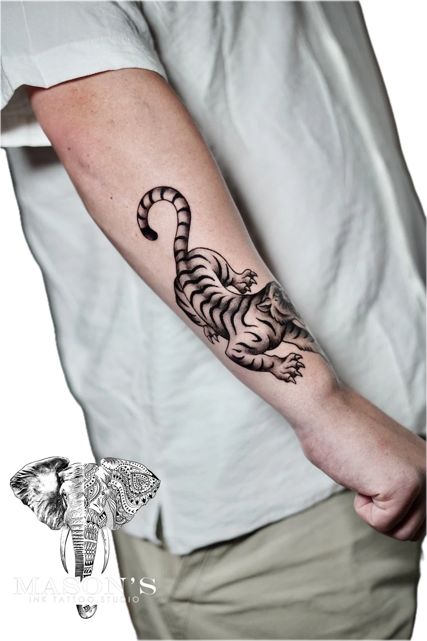 Traditional Tiger Tattoo Design: a detailed black and grey tiger tattoo on the forearm