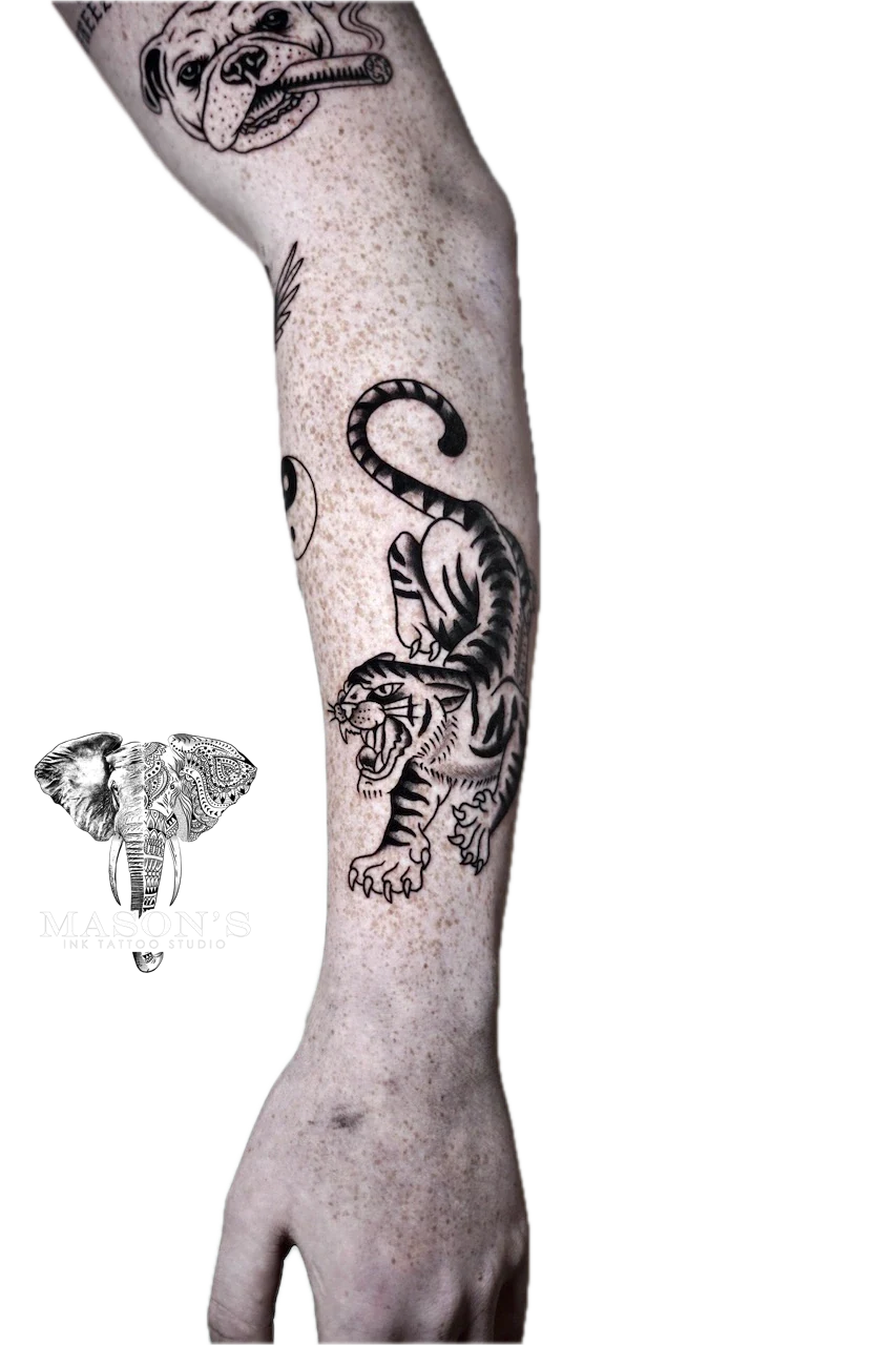 Traditional Tiger Tattoo Design: a large black and grey tiger and snake tattoo on a forearm