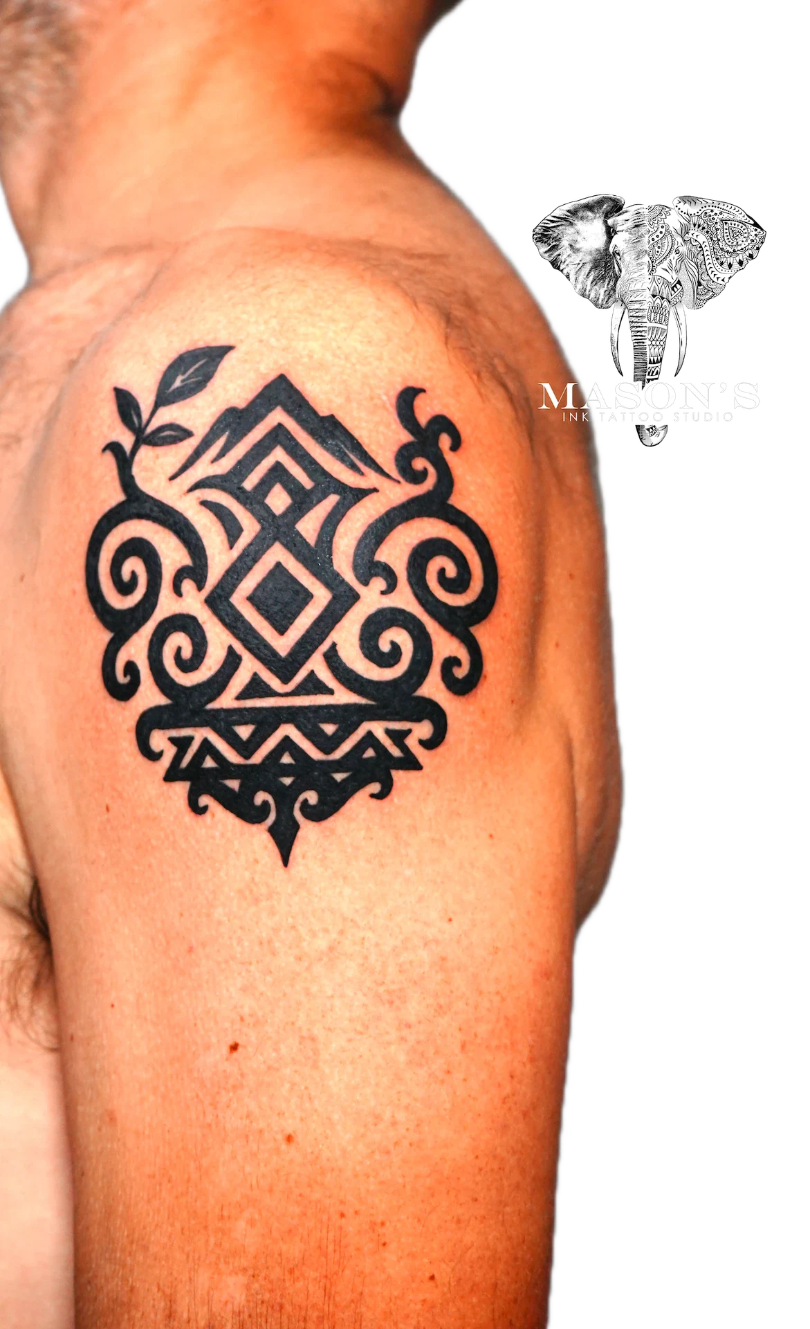 Tribal Tattoo Design: a detailed geometric pattern with swirls and a leaf on the upper arm