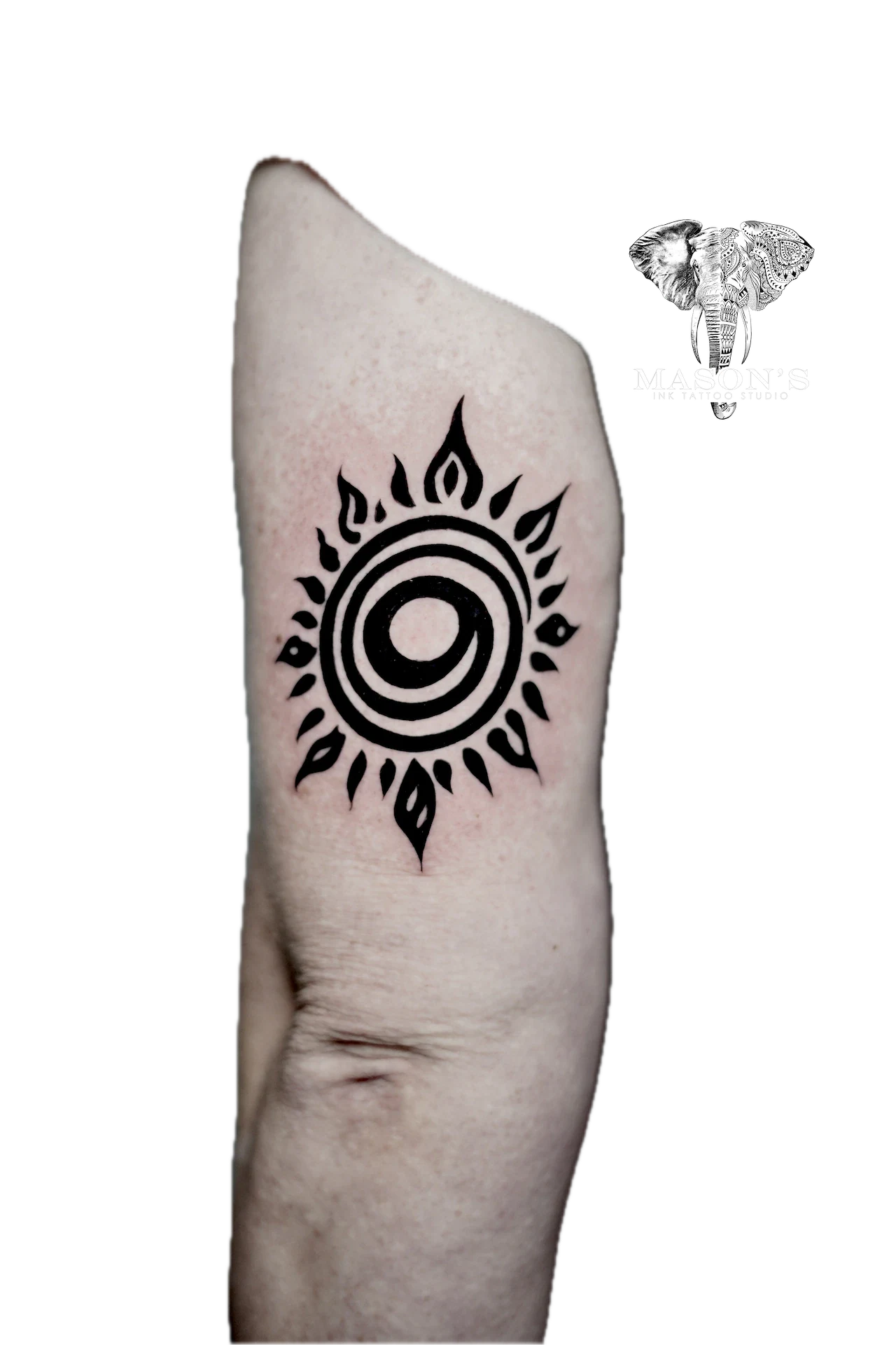Tribal Tattoo Design: a minimal sun design with circular patterns and flame-like rays