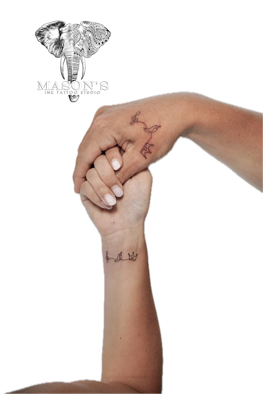 Fine Line Couple Tattoo Design: Minimalist wrist tattoos of a crown, bird, and musical notes